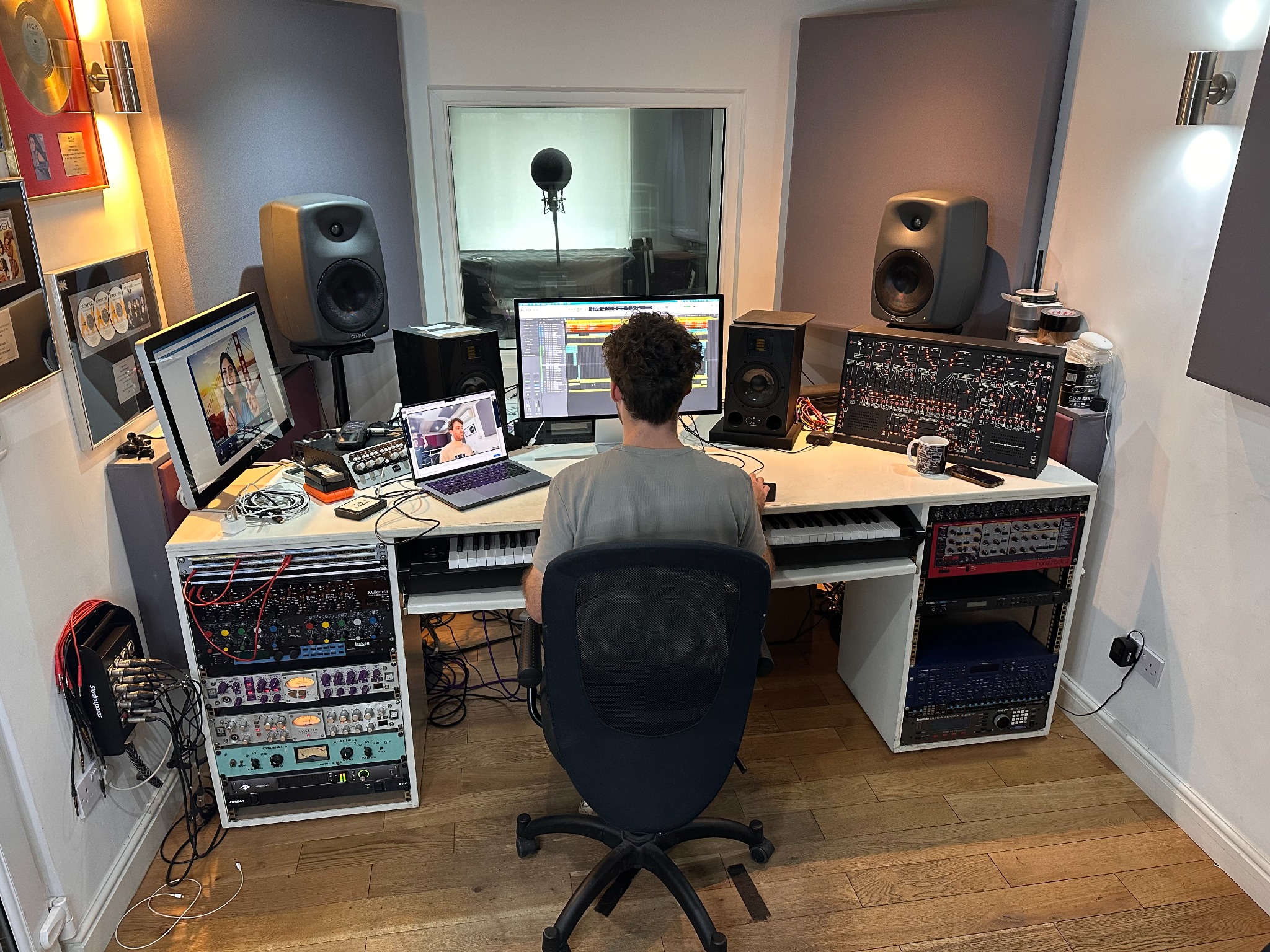 Engineer at Greystoke Studio recording desk with remote participants joining by video call